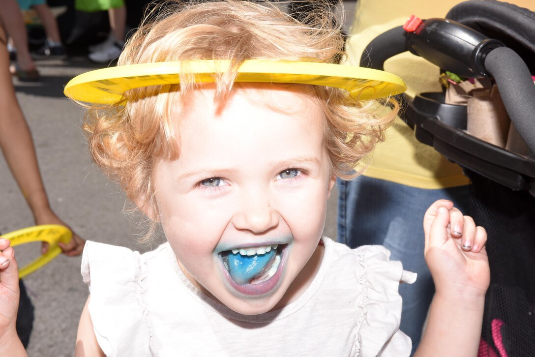 This little girl poses with a Corps of Engineers water safety frisbee she received from U.S. Army Corps of Engineers Nashville District booth during Earth Day festivities at Town Square in Murfreesboro, Tenn., April 23, 2016.  Her mouth was blue from eating a snow cone. 