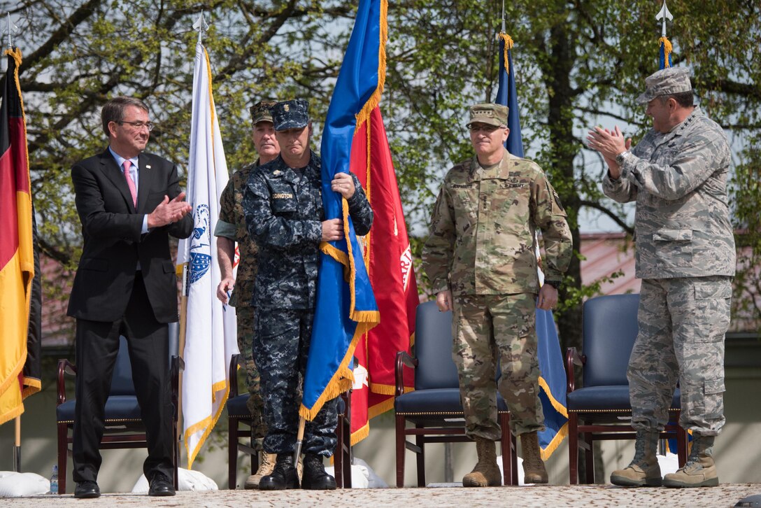 Defense Secretary Ash Carter, Marine Corps Gen. Joe Dunford, second from left, chairman of the Joint Chiefs of Staff, and Air Force Gen. Philip M. Breedlove, outgoing commander of U.S. European Command, applaud Army Gen. Curtis M. Scaparrotti, second from right, the command's new commander, during a ceremony in Stuttgart, Germany, May 3, 2016. DoD photo by D. Myles Cullen