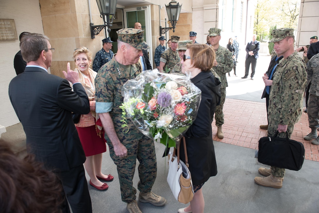 Marine Corps Gen. Joe Dunford, chairman of the Joint Chiefs of Staff, talks with Cindy Scaparrotti, the wife of Army Gen. Curtis M. Scaparrotti, the new commander of U.S. European Command, as she  holds a bouquet of flowers after the change-of-command ceremony in Stuttgart, Germany, May 3, 2016. DoD photo by D. Myles Cullen