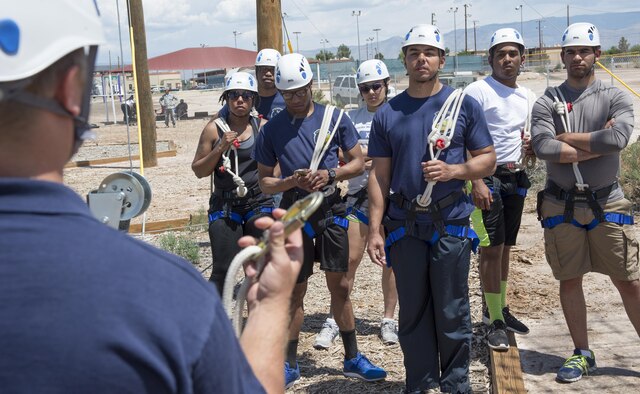 Airmen from the 49th Comptroller Squadron at Holloman Air Force, N.M., get instructions on how to use climbing equipment safely during a resiliency training exercise here in April. The staff at outdoor recreation hosts resiliency training exercises to help build team cohesion among Airmen. (U.S. Air Force photo by Airman 1st Class Randahl J. Jenson.)  