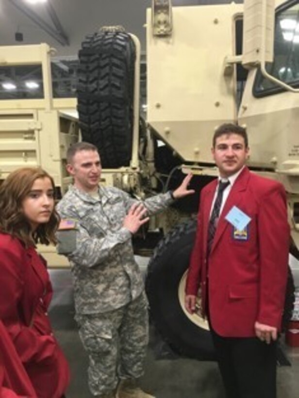Army Reserve Sgt. Karl N. Larew answers questions from SkillsUSA Competitors about a 1083 MTV, 27 Nov., 2015. Army Reserve Soldiers from the 758th Ordnance Company, 716th Transportation Battalion, 643rd Regional Support Group, 310th Sustainment Command (Expeditionary), supported the SkillsUSA State Competition with the US Army Columbus Recruiting Battalion at the Columbus Convention Center in Columbus, OH.