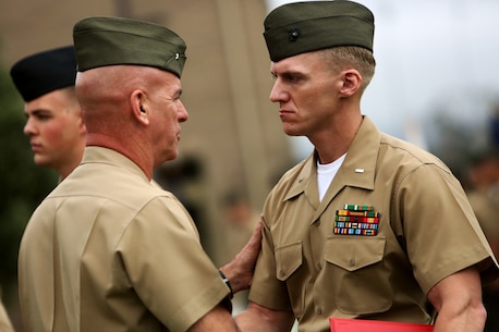 U.S. Marine 1st Lt. Frankie Doerr is handed an award during an awards ceremony aboard Camp Pendleton, Calif., April 22, 2016. Doerr is the 2nd platoon commander with Motor Transportation Company, Combat Logistics Battalion 5. Ten Marines and Sailors with 1st Marine Logistics Group were recognized for their outstanding performance throughout the year. Awards ranged from a Certificate of Commendation, Marine of the year, Noncommissioned Officer of the Year, and the Navy and Marine Corps Achievement Medal.  (U.S. Marine Corps photo by Sgt. Laura Gauna/released)