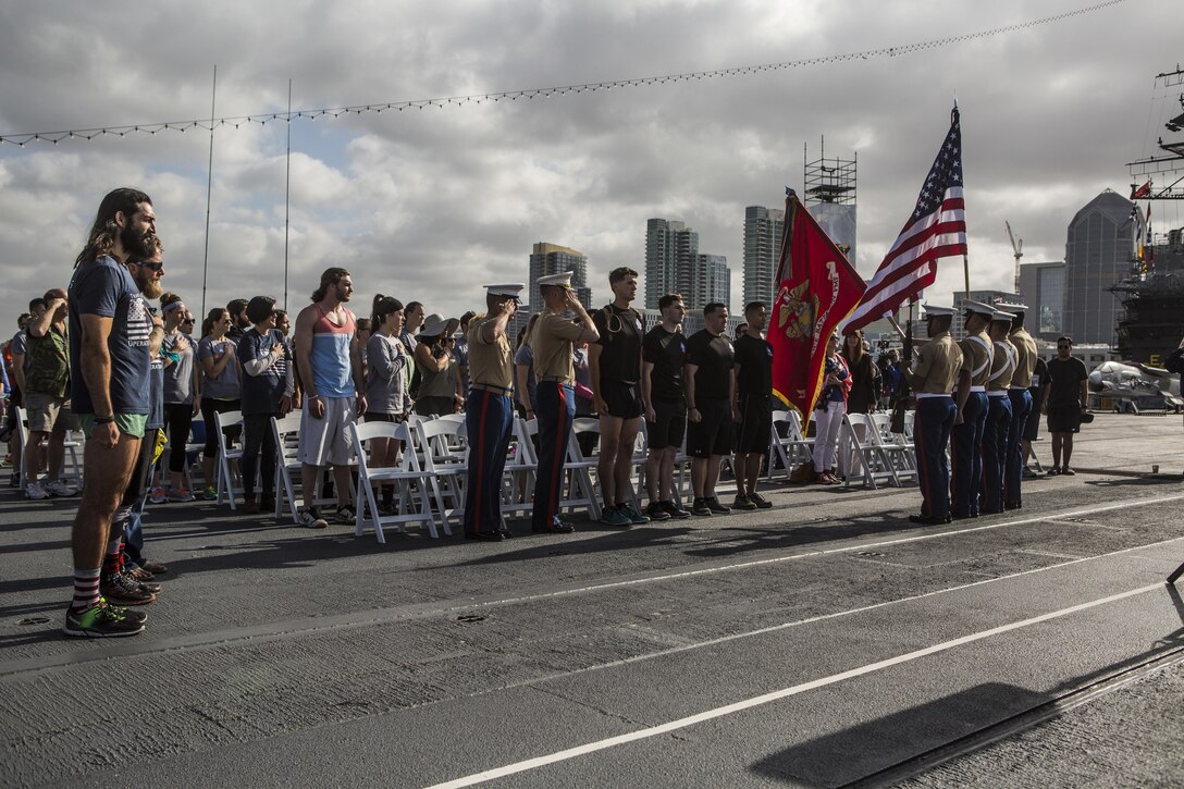 SAN DIEGO – Marines with 1st Reconnaissance Battalion honor the colors after running the last leg of a 1,500 mile run that members of the Travis Manion Foundation completed at the USS Midway in San Diego April 29, 2016. The run was in honor of Sam Leonard, who set out to walk across the country at age 73 to raise funds for the TMF, which supports veterans and families of the fallen and is named after a fallen recon Marine. Sam began in Florida but was forced to stop in Houston when he was diagnosed with stage 4 stomach cancer. He sadly passes away four months later. The three men with TMF decided to pick up where he left off and finish the last 1,500 mile of his trek in his honor. Cpl. Zachary Morgan, a reconnaissance Marine with 1st Recon Bn., ran the last six miles with the three men on this trek. “It feels good to be a part of this run because I know if I was in their shoes, it would mean a lot to see support from people,” said Morgan. “It really opens your eyes seeing people do these kinds of things as to what’s possible for you and what you can do in the future if you set your mind to it, it’s very inspiring.” (U.S. Marine corps photo by Sgt. Anna Albrecht/ Released)