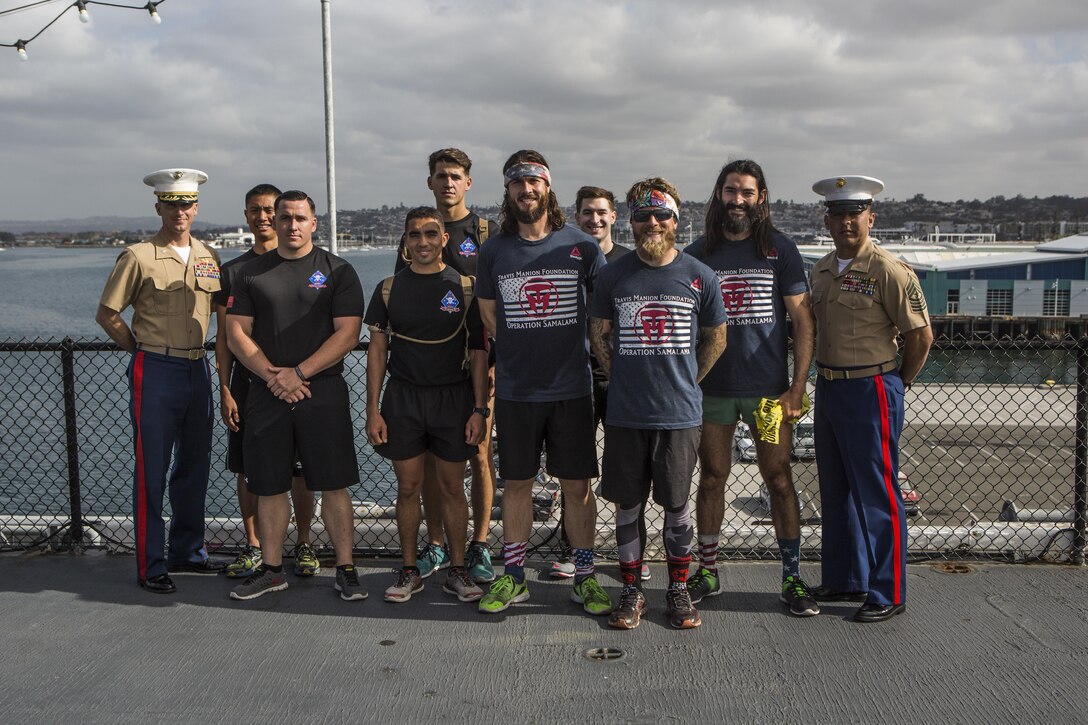 SAN DIEGO – Marines with 1st Reconnaissance Battalion pose with Albie Masland, Nick Biase and Matt Peace, from the Travis Manion Foundation on the USS Midway April 29, 2016. The run was in honor Sam Leonard, who set out to walk across the country at age 73 to raise funds for the TMF, which supports veterans and families of the fallen and is named after a fallen reconnaissance Marine. Sam began in Florida but was forced to stop in Houston when he was diagnosed with stage 4 stomach cancer. He sadly passed away four months later. Albie, the TMF west coast veteran service manager reached out to his good friends and TMF ambassadors, Nick and Matt, to see if they wanted to help honor Sam by completing the last 1,500 miles of his journey and raise money for the TMF on his behalf. They finished the trek in 30 days and on the anniversary of Travis Manion's death. (U.S. Marine Corps photo by Sgt. Anna Albrecht/Released)