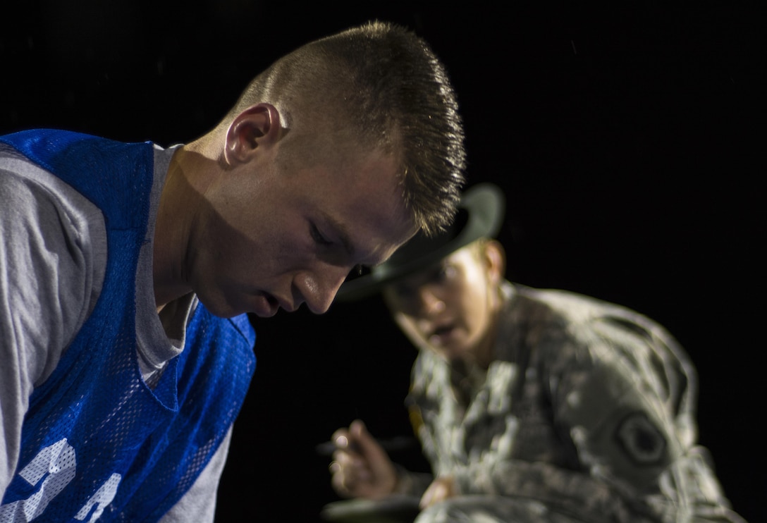 Army Reserve drill sergeant, Staff Sgt. Angela Lee, 1st Bn., 518th Inf. Reg., 98th Training Div. (IET), grades the push-ups of Spc. Christopher Elam, 335th Signal Command (Theater), a competitor participating in the 2016 U.S. Army Reserve Best Warrior Competition at Fort Bragg, N.C., May 3.Soldiers competing for the title of Army Reserve Best Warrior began a rainy Tuesday morning taking the Army Physical Fitness Test at Hedrick Stadium on the post. This year’s Best Warrior Competition will determine the top noncommissioned officer and junior enlisted Soldier who will represent the U.S. Army Reserve in the Department of the Army Best Warrior Competition later this year at Fort A.P. Hill, Va.  (U.S. Army photo Sgt. 1st Class Brian Hamilton/released)