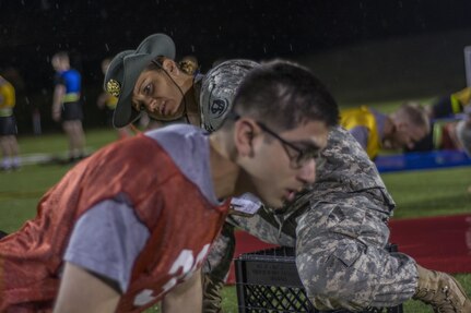 Army Reserve drill sergeant, Sgt. 1st Class Kelly Foronda, 95th Training Div. (IET), checks to ensure if Sgt. Muhammad Ali,, 3rd Medical Command (Deployment Support), completes a successful push-up during the Army Physical Fitness Test at the 2016 U.S. Army Reserve Best Warrior Competition at Fort Bragg, N.C., May 3. Soldiers competing for the title of Army Reserve Best Warrior began a rainy Tuesday morning taking the Army Physical Fitness Test at Hedrick Stadium on the post. This year’s Best Warrior Competition will determine the top noncommissioned officer and junior enlisted Soldier who will represent the U.S. Army Reserve in the Department of the Army Best Warrior Competition later this year at Fort A.P. Hill, Va.  (U.S. Army photo Sgt. 1st Class Brian Hamilton/released)