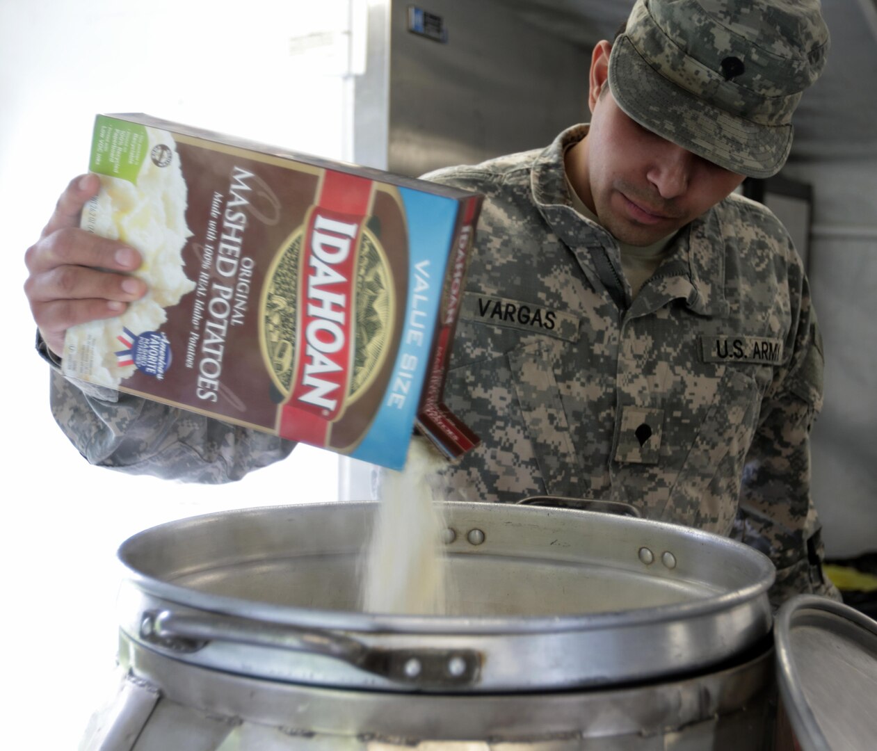 New York Army National Guard Private Spc. Ramon Vargas, a food service specialist with the 642nd Aviation Service Battalion, adds mashed potato mix to a pot of boiling water during the state level Phillip A. Connelly Competition at Camp Smith Training Site on April 29, 2016.  



