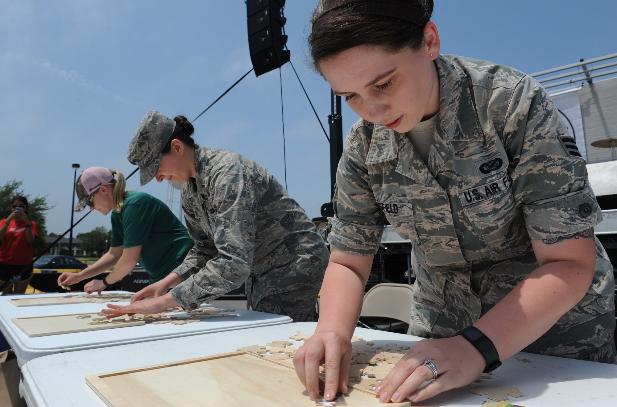 Senior Airman Holly Mansfield, 81st Training Wing Public Affairs photojournalist, assembles a puzzle during a burger burn April 29, 2016, Keesler Air Force Base, Miss. The burger burn was the final event of Wingman Week in support of Comprehensive Airman Fitness. (U.S. Air Force photo by Kemberly Groue)