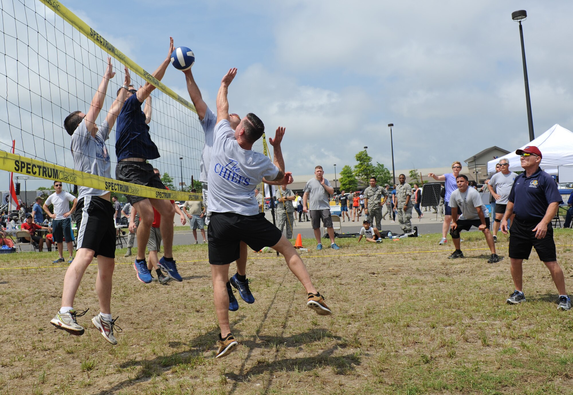 Members of the 81st Training Group volleyball team and “The Chiefs” play volleyball during a burger burn April 29, 2016, Keesler Air Force Base, Miss. The burger burn was the final event of Wingman Week in support of Comprehensive Airman Fitness. (U.S. Air Force photo by Kemberly Groue)