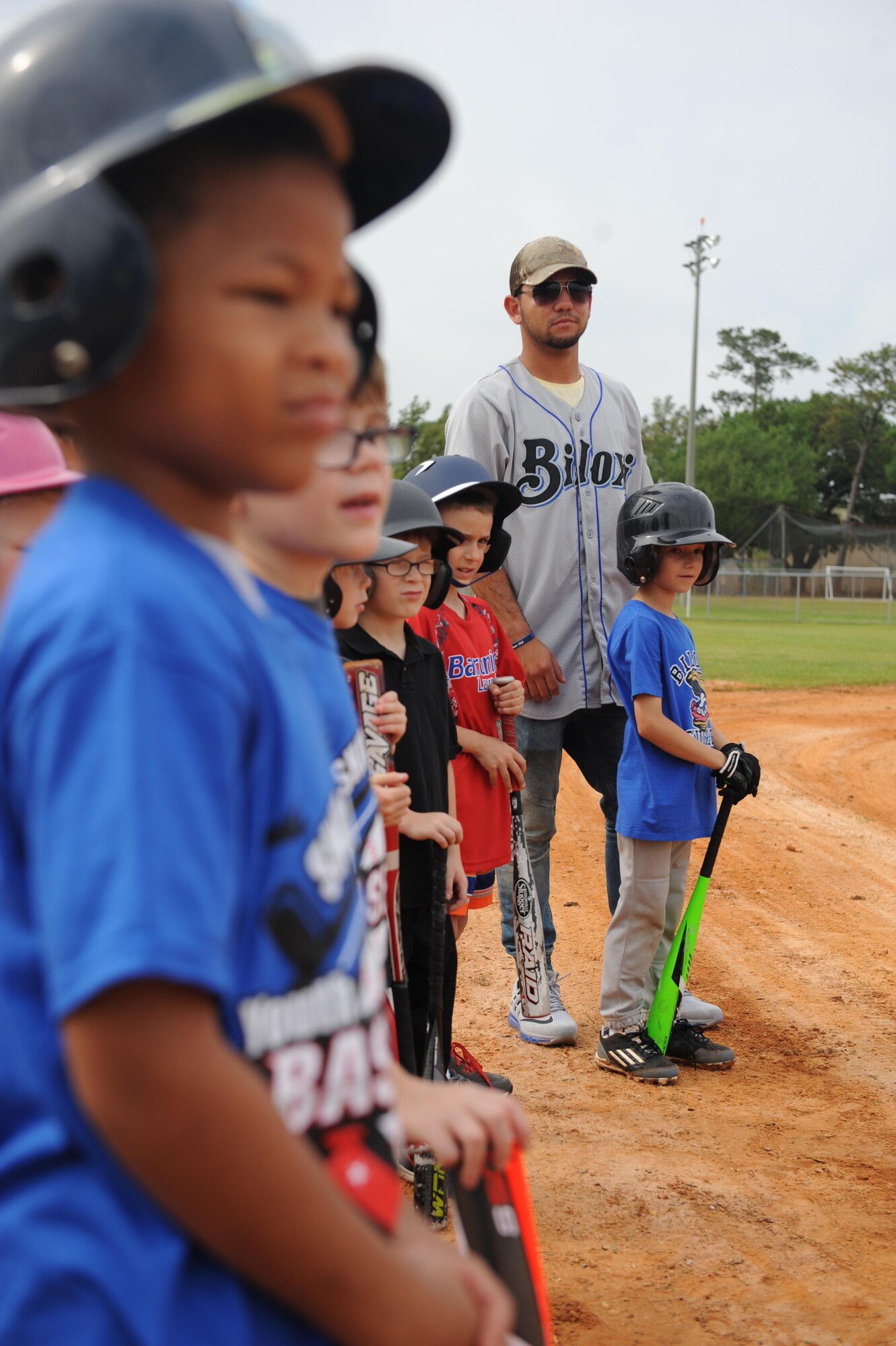 Javier Betancourt, Biloxi Shuckers second baseman, stands with Keesler children before swinging practice during the Biloxi Shucker’s Youth Baseball Clinic at the youth center baseball field April 30, 2016, Keesler Air Force Base, Miss. The clinic provided hitting, pitching, base running and fielding instruction from members of the Biloxi Shucker’s minor league baseball team. (U.S. Air Force photo by Kemberly Groue)