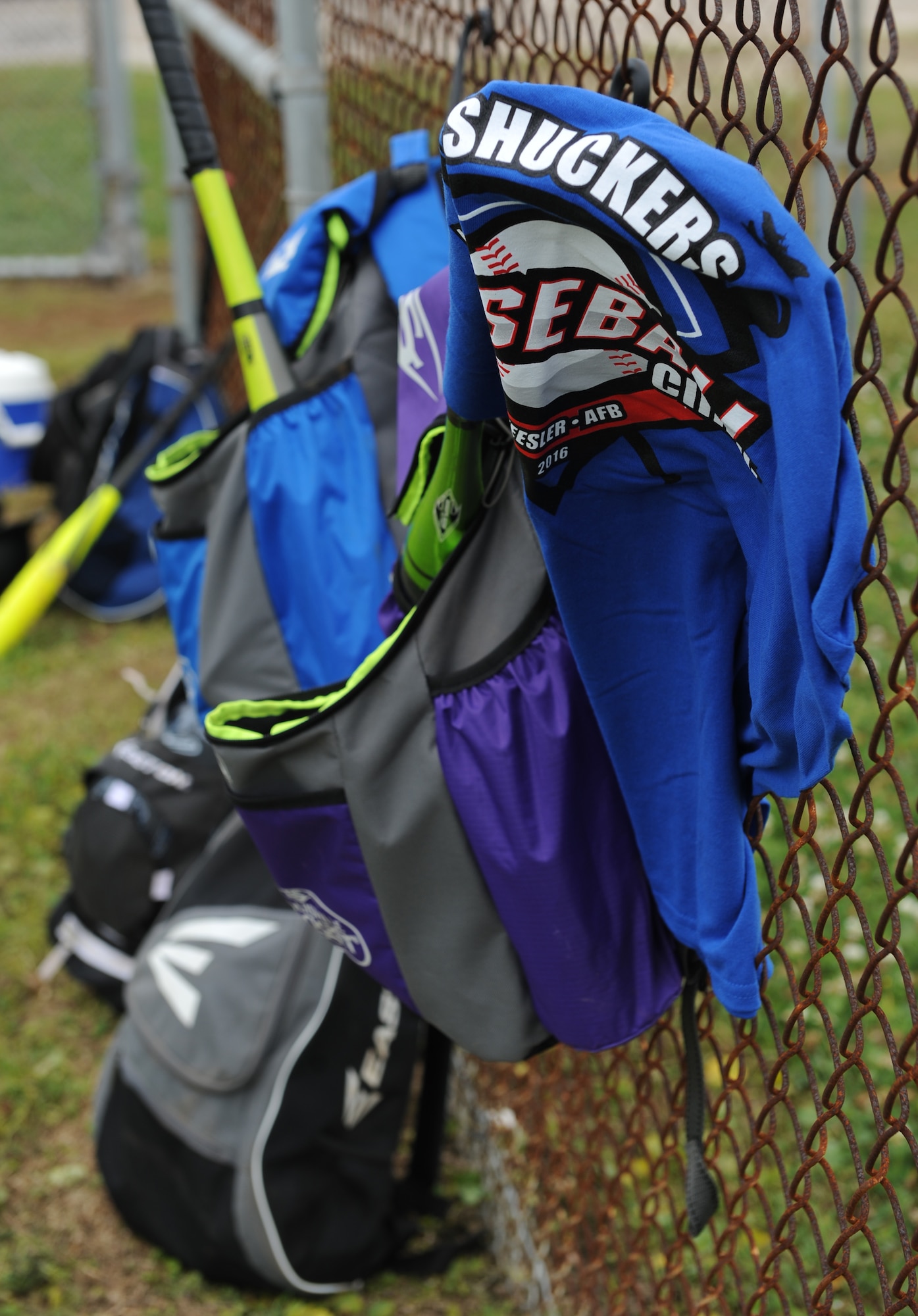 Baseball equipment and a T-shirt hangs from a fence during the Biloxi Shucker’s Youth Baseball Clinic at the youth center baseball field April 30, 2016, Keesler Air Force Base, Miss. The clinic provided hitting, pitching, base running and fielding instruction from members of the Biloxi Shucker’s minor league baseball team.  (U.S. Air Force photo by Kemberly Groue)