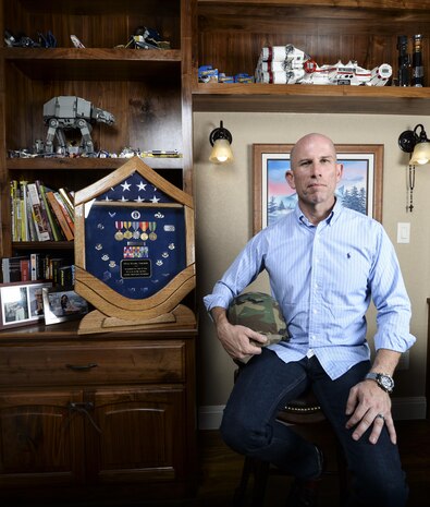 Daniel Schaeler, a nuclear quality assurance inspector in the aerospace industry, poses next to career memorabilia displayed in his Texas home July 18, 2014. Schaeler is a former Air Force logistician who retired after 24 years of service. (U.S. Air Force photo/Staff Sgt. Kevin Iinuma)