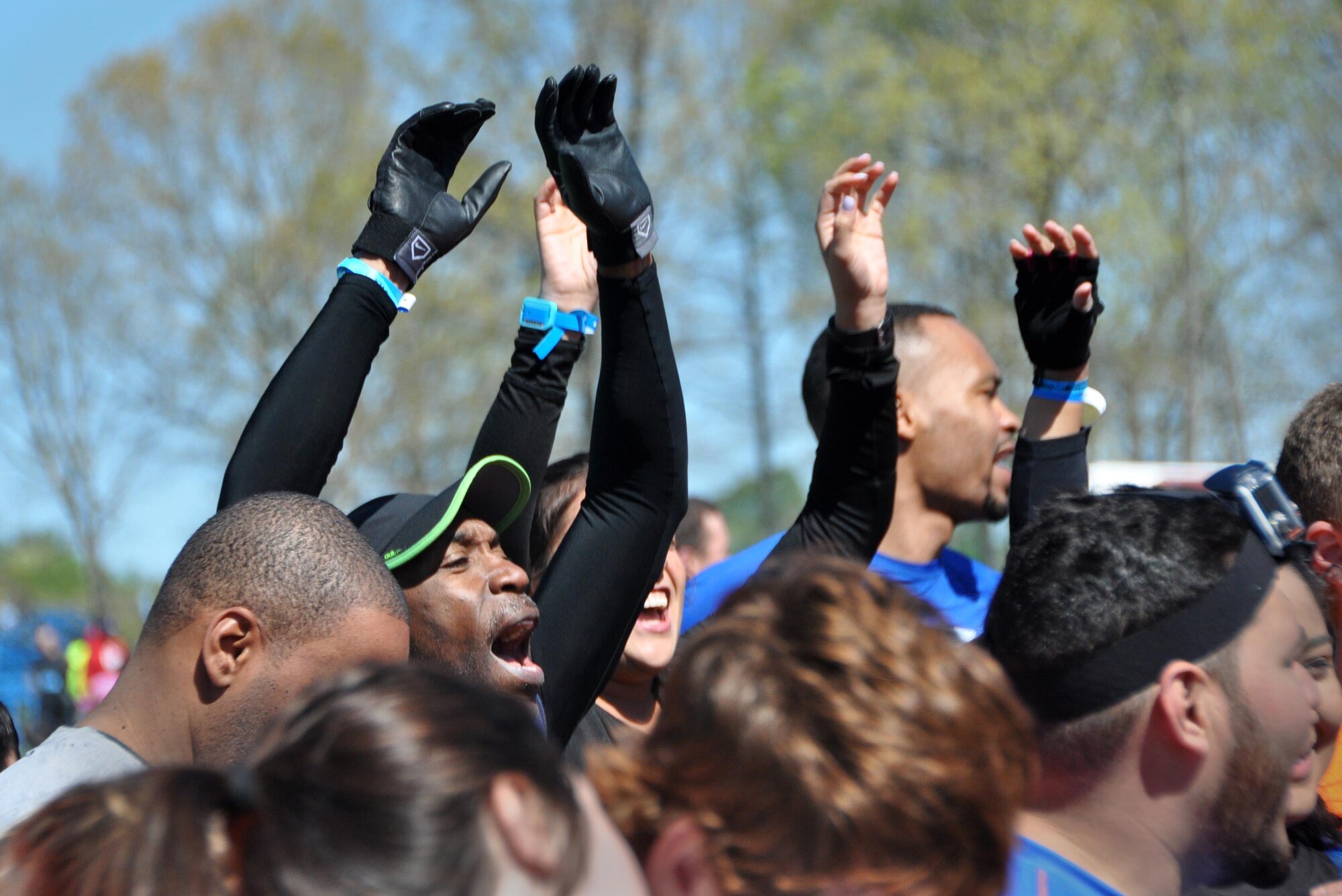 Senior Master Sgt. Eric Jones, 94th Logistics Readiness Squadron, and Capt. Natalie Campos, 22nd Air Force executive officer, show their excitement at the starting line of the Savage Race on April 9, 2016 in Dallas, Georgia. The Savage Race is an obstacle course and running trail that was created to push people to their physical limit and encourage teamwork. (U.S. Air Force photo by Senior Airman Lauren Douglas)