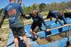 Recruiters from Dobbins Air Reserve Base, Ga. help a fallen member that almost made it to the end of the Pole Cat obstacle at the Savage Race on April 9, 2016 in Dallas, Georgia. The participants proudly showed the spirit of never leaving a wingman behind. (U.S. Air Force photo by Senior Airman Lauren Douglas)