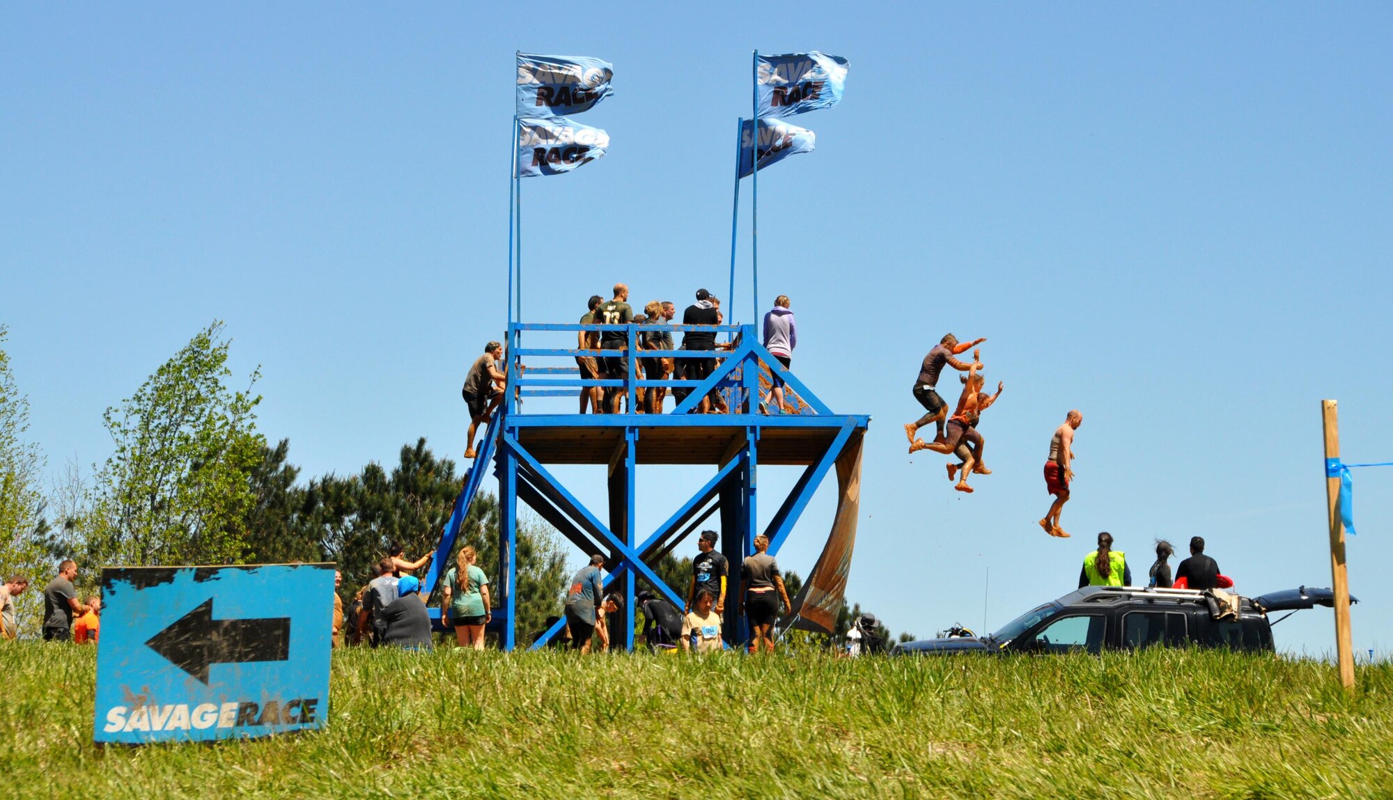 Members of Dobbins Air Reserve Base, Ga. and many other racers from Georgia take a leap of faith at Davy Jones Locker obstacle at the Savage Race on April 9, 2016 in Dallas, Georgia. Davy Jones Locker is a 15-foot high dive into a 15 foot deep pool. (U.S. Air Force photo by Senior Airman Lauren Douglas)