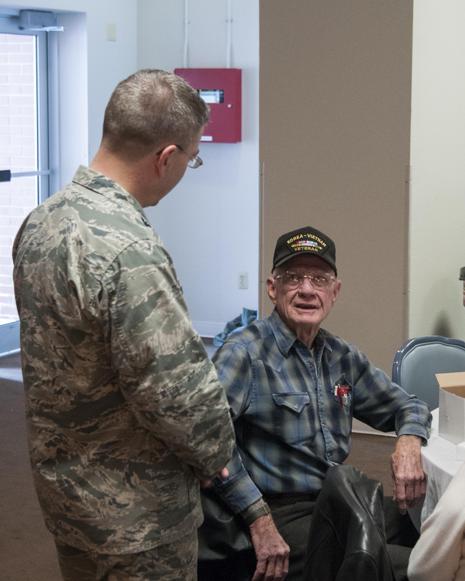 Retired Master Chief Petty Officer Norvan Roediger talks with Col. Hans Ritschard, 90th Medical Group commander, during the 90th MDG's Retiree Appreciation Day April 30, 2016, on F.E. Warren Air Force Base, Wyo. The MDG and base Retiree Activities Office collaborate each year to put on the event to show gratitude for retirees' service and give them information about their benefits. (U.S. Air Force photo by Senior Airman Jason Wiese)