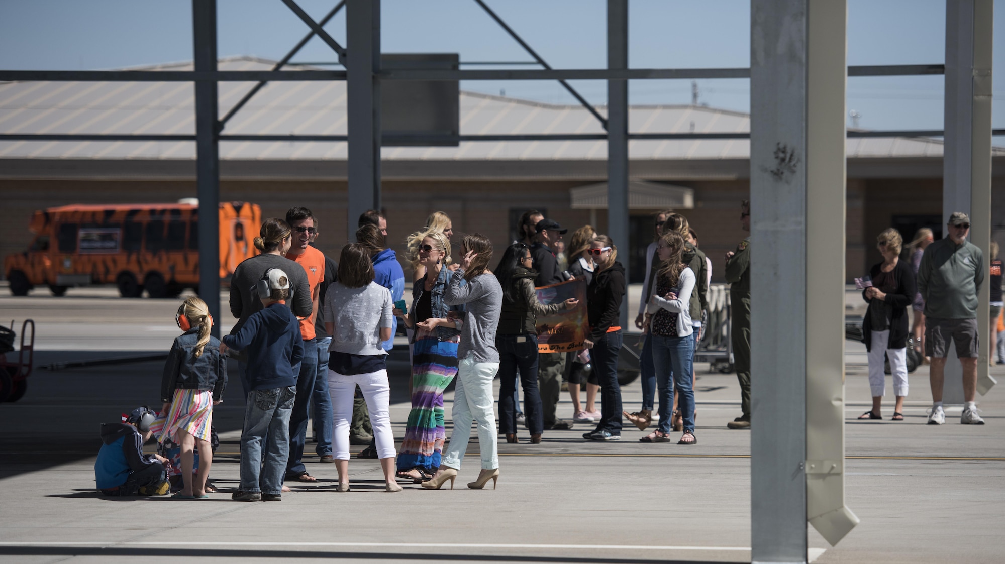 Family members gather, waiting for their loved ones returning from deployment, at Mountain Home Air Force Base, Idaho, April 17, 2016. Airmen from the 391st Fighter Squadron were deployed in support of Operation Inherent Resolve. (U.S. Air Force photo by Airman Alaysia Berry/Released)