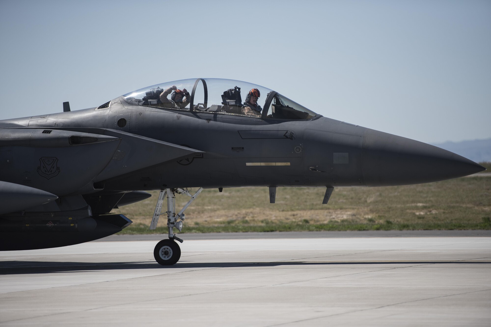 An weapons systems officer cheers as he returns from deployment April 17, 2016, at Mountain Home Air Force Base, Idaho. He was deployed in support of Operation Inherent Resolve. (U.S. Air Force photo by Airman Alaysia Berry/Released)