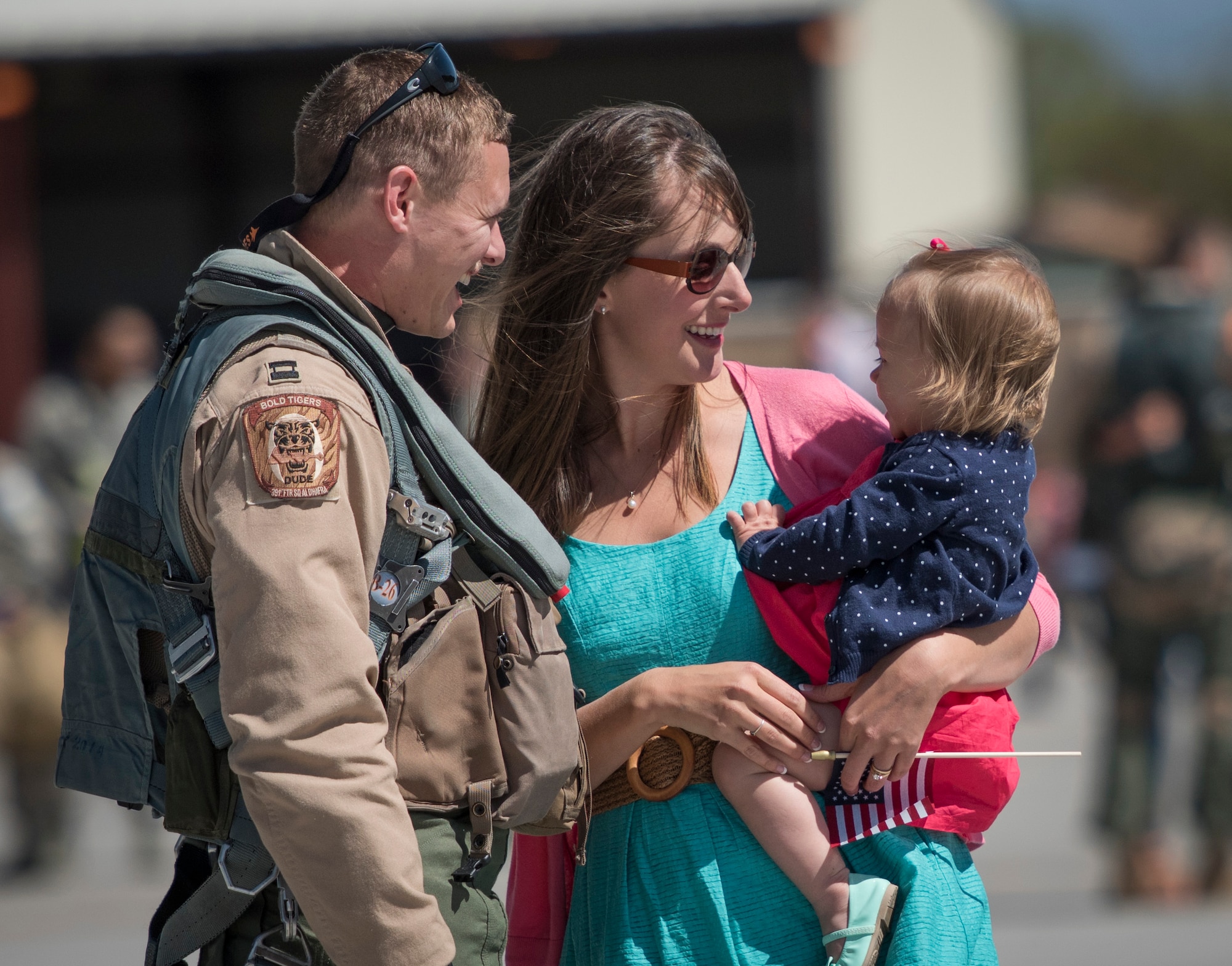 A family reunites after a deployment April 17, 2016, at Mountain Home Air Force Base, Idaho. The airman served six months in Southwest Asia. (U.S. Air Force photo by Airman Alaysia Berry/Released)