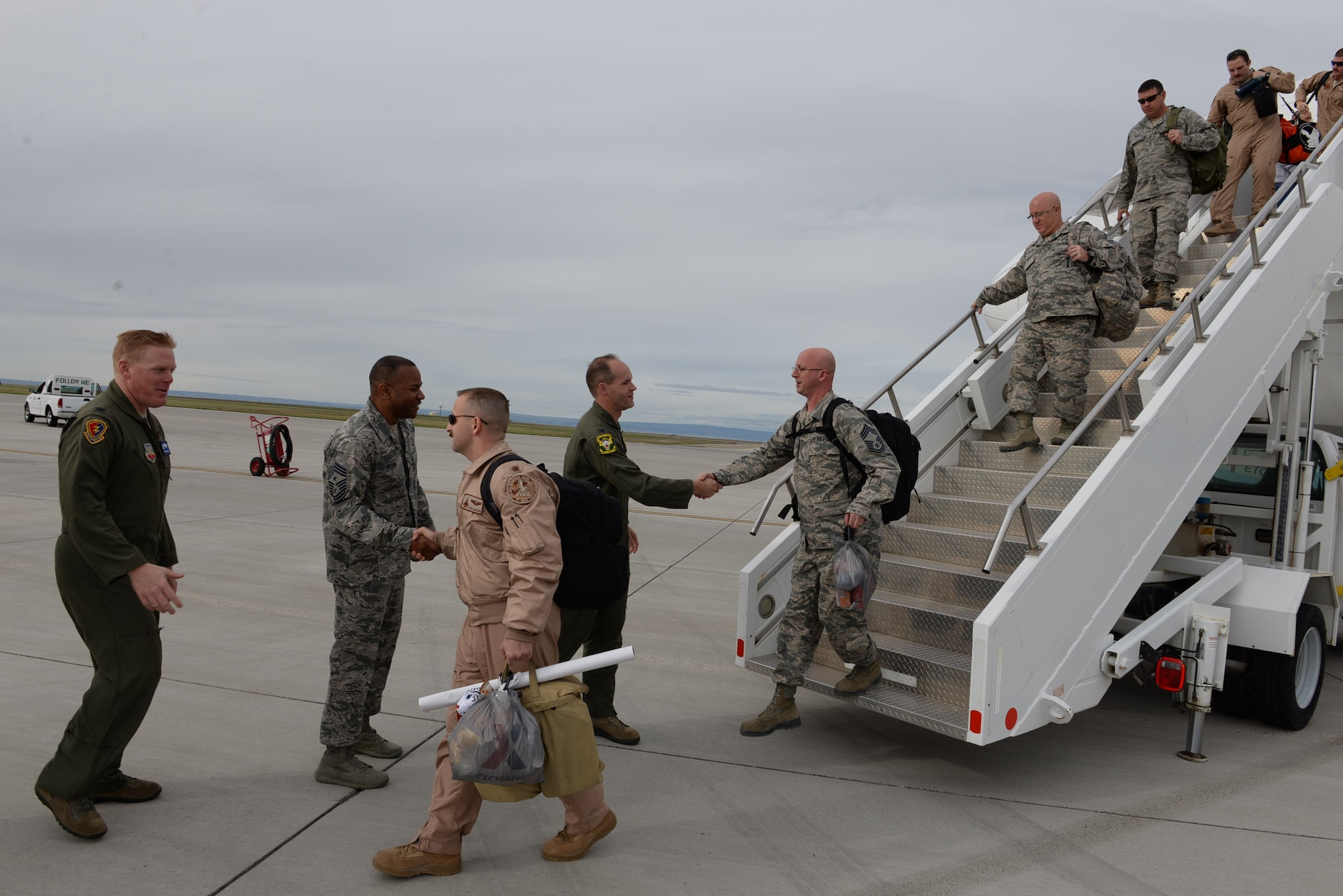 Col. Jefferson O'Donnell, 366th Fighter Wing commander, and Chief Master Sgt. David Brown, 366th Fighter Wing command chief, welcome returning airmen April 24, 2016, at Mountain Home Air Force Base, Idaho. The airmen were deployed in support of Operation Inherent Resolve. (U.S. Air Force photo by Airman 1st Class Chester Mientkiewicz/Released)