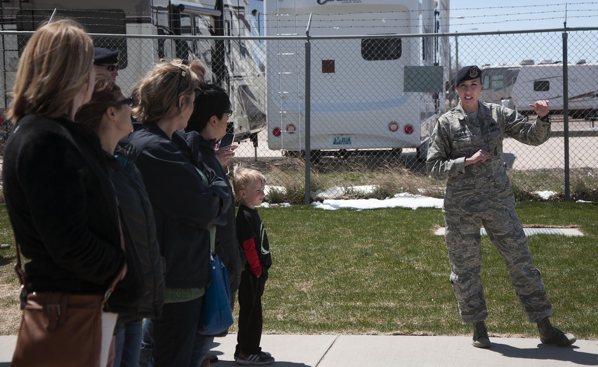 Staff Sgt. Kathryn Goldman, 90th Security Forces Group Military Working Dogs trainer, speaks with spouses and children of Airmen May 2, 2016, during the 90th SFG spouse’s appreciation week event at the MWD facility. The demonstration showcased canine training and explained their role in the group mission. (U.S. Air Force photo by Senior Airman Brandon Valle)