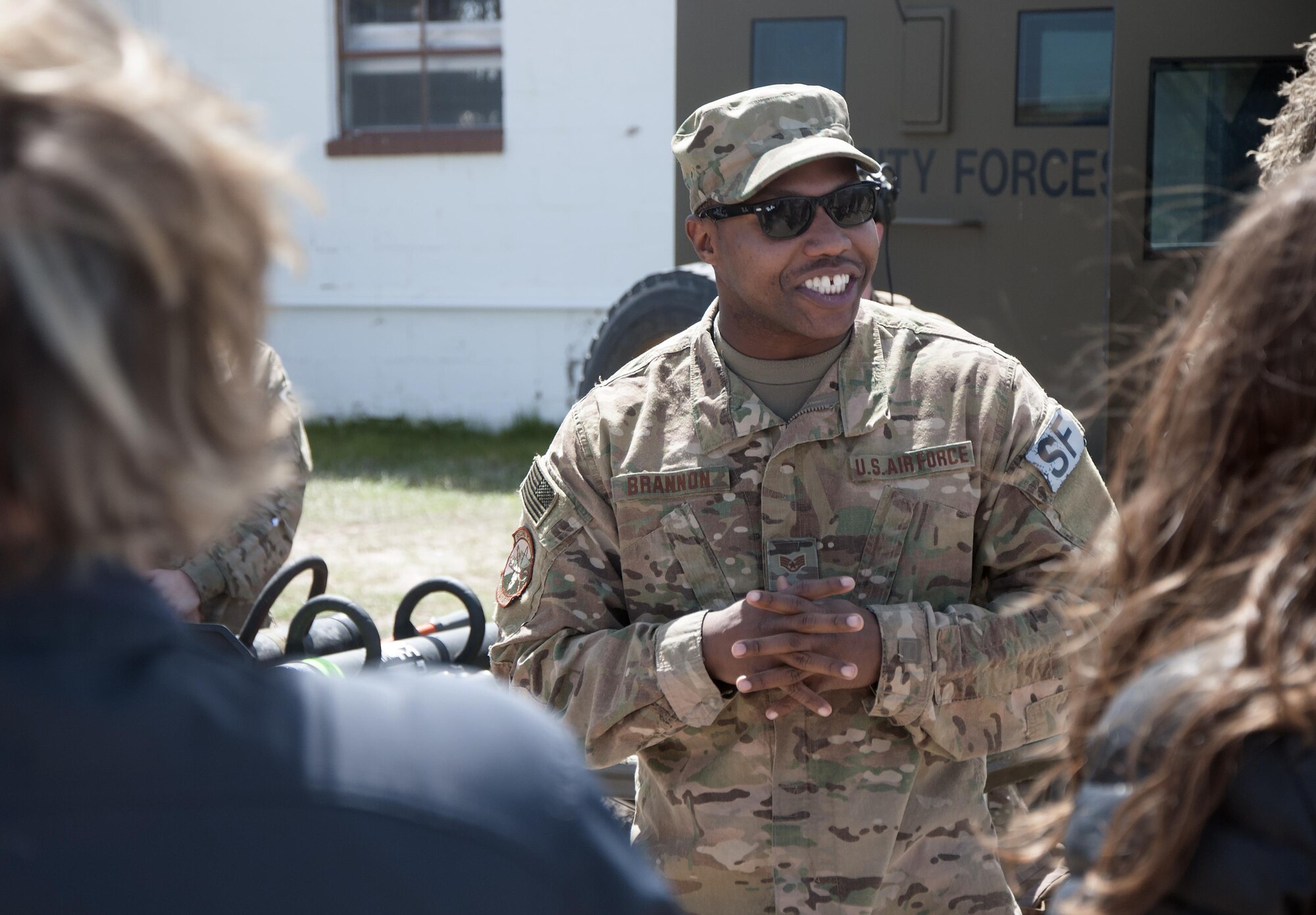 Staff Sgt. Avery Brannon, 790th Missile Security Forces Squadron Tactical Response Force assaulter, briefs the mission of the TRF to spouses and children of Mighty Ninety Airmen may 2, 2016, outside of the 90th Security Forces Group Military Working Dogs facility. The event was the first of four spouses appreciation week events planned by the groups of the 90th Missile Wing. (U.S. Air Force photo by Senior Airman Brandon Valle)