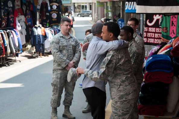 Prince Enyioko thanks Tech. Sgt. Stefan Hanyes, 51st Force Support Squadron, for helping save the lives of his wife and three children from a fire at Songtan shopping district, Republic of Korea, May 2, 2016. Service members from the 51st Fighter Wing, 8th Fighter Wing and 35th Air Defense Artillery Brigade came together to rescue the family from the burning building on April 29, 2016. (U.S. Air Force photo by Staff Sgt. Jonathan Steffen/Released)