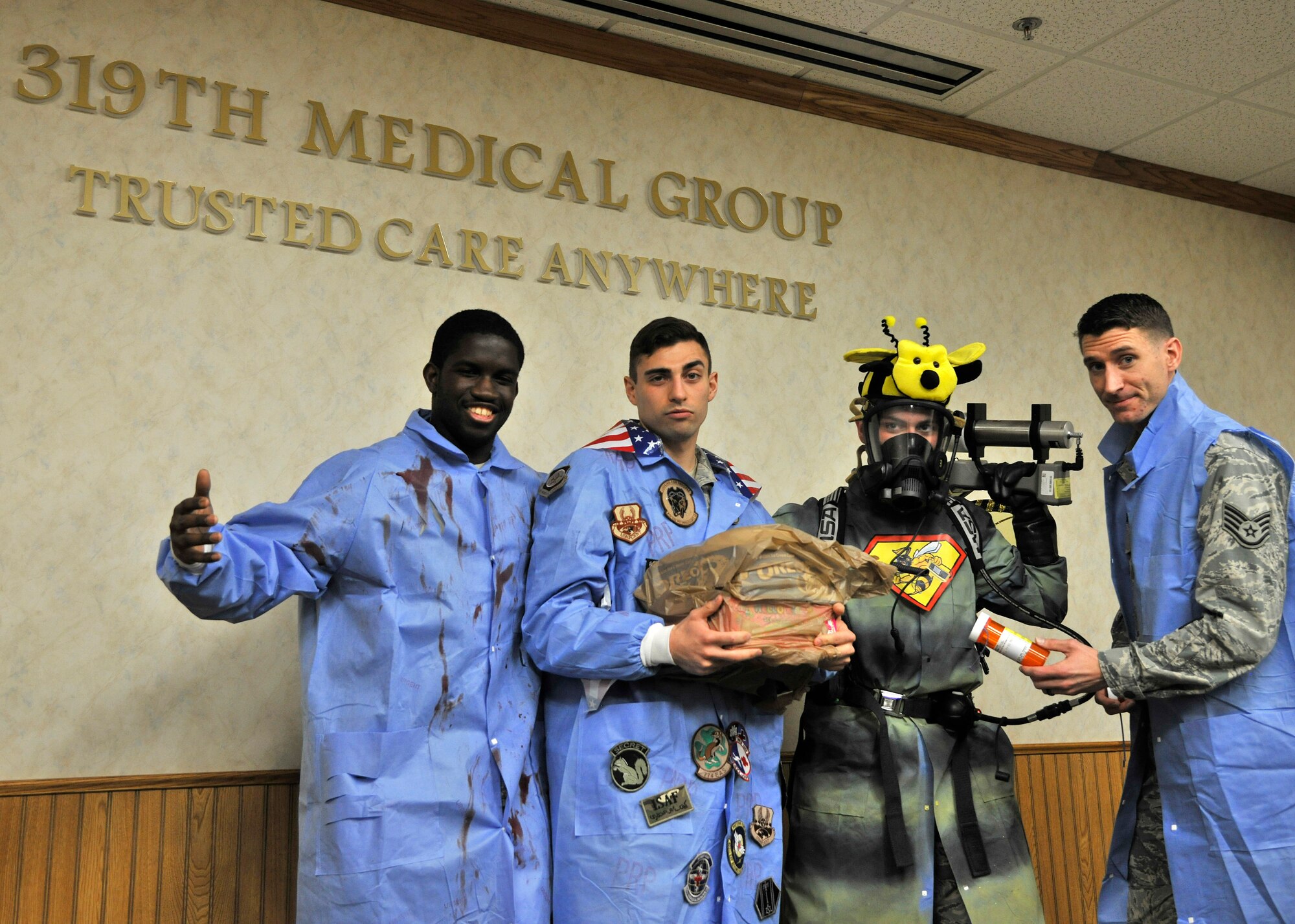 Members of the 319th Medical Group pose for a photo after a laboratory coat walk-off during the 2016 Medical Laboratory Professionals Week (MLPW) April 27, 2016 on Grand Forks Air Force Base, N.D. The MLPW provides the profession with a unique opportunity to increase public understanding of and appreciation for clinical laboratory personnel which takes place the last full week in April each year. (U.S. Air Force photo by Senior Airman Xavier Navarro)
