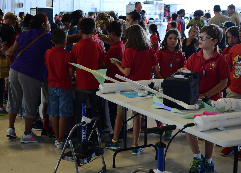Children from local Tampa schools launch paper rockets with compressed air during School Day April 29, 2016, at MacDill Air Force Base, Fla. This was one of the science, technology, engineering and mathematics activities the children participated in. (U.S. Air Force photo by Airman Adam R. Shanks)