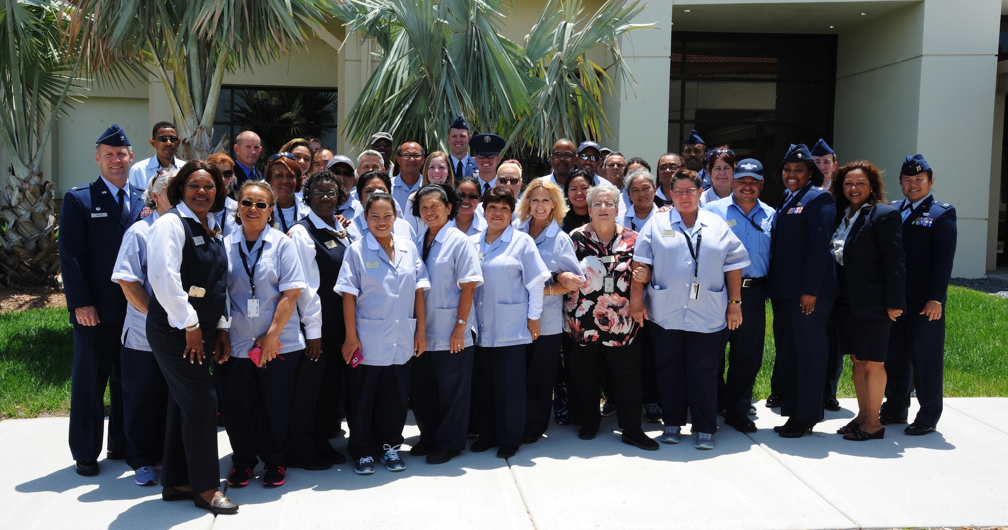 Faculty and staff from the newly opened MacDill Inn pose for a group photo after the ribbon cutting ceremony on MacDill Air Force Base, Fla., May 2, 2016. The MacDill Inn opened to provide more lodging for temporary duty assignment travelers. (U.S. Air Force photo by Airman Adam R. Shanks)