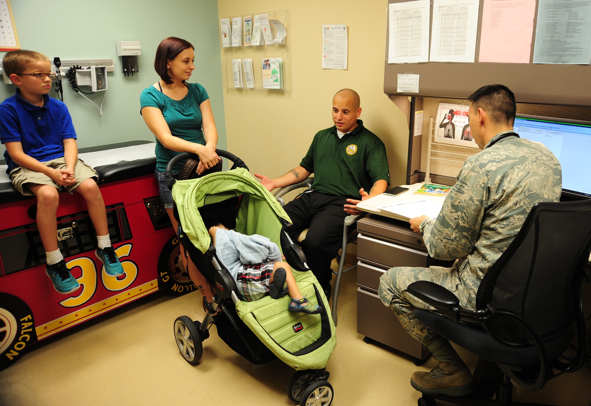 Maj. James Tschudy, a pediatrician with the 6th Medical Operations Squadron, discusses medical options with the parents of a patient during a routine check-up at MacDill Air Force Base, Fla., April 21, 2016. As a former military child, Tschudy relates to the lifestyle and challenges military children face and loves taking care of military children because military children are amazing and resilient. (U.S. Air Force photo by Senior Airman Jenay Randolph)

