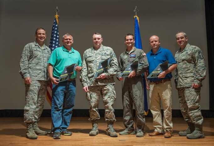 Airmen and civilians from the 437th Airlift Wing pose for a group photo with Col. John Lamontagne, 437th AW commander, and Chief Master Sgt. Kristopher Berg, 437th AW command chief, during a quarterly awards ceremony April 27, 2016, at Joint Base Charleston, S.C. The winners for the quarter are: Senior Airman Grant Smart, Tech. Sgt. William Brady, Master Sgt. William Henke, Captain Peter Theisen, Bryan Deal and John Speaks. (U.S. Air Force photo/Staff Sgt. Jared Trimarchi) 