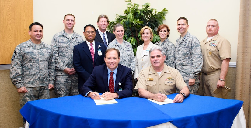 Todd Gallati, Trident Medical Center CEO, and Navy Capt. Tim Sparks, Joint Base Charleston deputy commander, sign a memorandum of agreement April 21, 2016, at the Redbank Club on Joint Base Charleston – Weapons Station, S.C. This partnership program joins military and civilian leaders to brainstorm ideas for leveraging resources. (U.S. Air Force photo/Senior Airman Clayton Cupit)