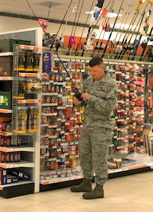 Tech. Sgt. Luke Bollenberg, a 437th Airlift Wing C-17 Globemaster III crew chief, browses the fishing section of the Joint Base Charleston Exchange April 20, 2016. Some of the benefits of the Exchanges include purchases being tax free, offering a price match program and money spent at the Exchange is used to improve military communities. (U.S. Air Force Photo/Airman Megan Munoz)
