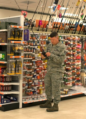 Tech. Sgt. Luke Bollenberg, a 437th Airlift Wing C-17 Globemaster III crew chief, browses the fishing section of the Joint Base Charleston Exchange April 20, 2016. Some of the benefits of the Exchanges include purchases being tax free, offering a price match program and money spent at the Exchange is used to improve military communities. (U.S. Air Force Photo/Airman Megan Munoz)