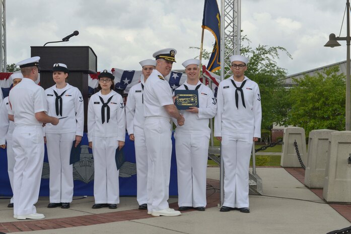 Capt. John Meier, guest speaker, presents the commanding officer's personal excellence award to Machinists Mate 3rd Class (Nuclear) Brian Hickman during the graduation ceremony of Nuclear Power School class 1601 at Naval Nuclear Power Training Command (NNPTC) on April 22, 2016. Based at Joint Base Charleston-Naval Weapons Station, NNPTC trains Sailors in the fundamentals of design, operation, and maintenance of shipboard nuclear propulsion plants. (U.S. Navy Photo by Mass Communication Specialist 2nd Class Corey Dill)