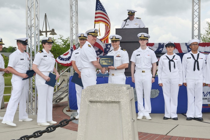 Capt. John Meier, guest speaker, presents the commanding officer's personal excellence award to Ltjg. Richard Daos during the graduation ceremony of Nuclear Power School class 1601 at Naval Nuclear Power Training Command (NNPTC) on April 22, 2016. Based at Joint Base Charleston-Naval Weapons Station, NNPTC trains Sailors in the fundamentals of design, operation, and maintenance of shipboard nuclear propulsion plants. (U.S. Navy Photo by Mass Communication Specialist 2nd Class Corey Dill)