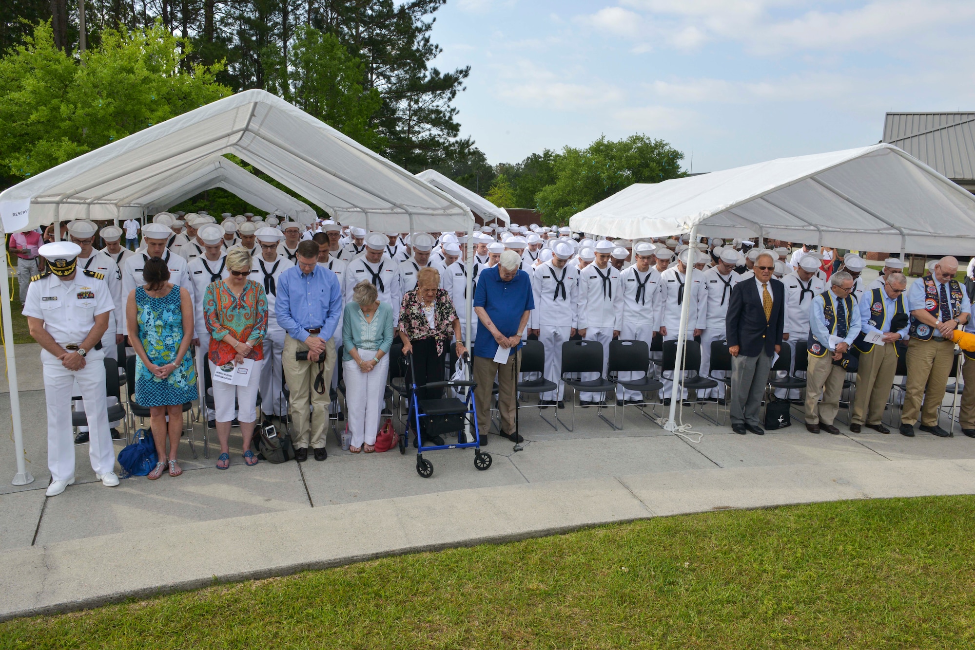 Sailors and family members bow their heads in prayer during the graduation ceremony of Nuclear Power School class 1601 at Naval Nuclear Power Training Command (NNPTC) on April 22, 2016. Based at Joint Base Charleston-Naval Weapons Station, NNPTC trains Sailors in the fundamentals of design, operation, and maintenance of shipboard nuclear propulsion plants. (U.S. Navy Photo by Mass Communication Specialist 2nd Class Corey Dill)