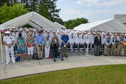 Sailors and family members bow their heads in prayer during the graduation ceremony of Nuclear Power School class 1601 at Naval Nuclear Power Training Command (NNPTC) on April 22, 2016. Based at Joint Base Charleston-Naval Weapons Station, NNPTC trains Sailors in the fundamentals of design, operation, and maintenance of shipboard nuclear propulsion plants. (U.S. Navy Photo by Mass Communication Specialist 2nd Class Corey Dill)