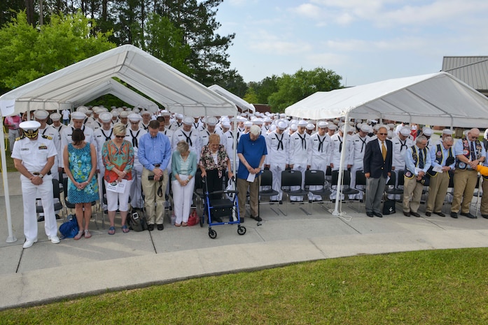 Sailors and family members bow their heads in prayer during the graduation ceremony of Nuclear Power School class 1601 at Naval Nuclear Power Training Command (NNPTC) on April 22, 2016. Based at Joint Base Charleston-Naval Weapons Station, NNPTC trains Sailors in the fundamentals of design, operation, and maintenance of shipboard nuclear propulsion plants. (U.S. Navy Photo by Mass Communication Specialist 2nd Class Corey Dill)