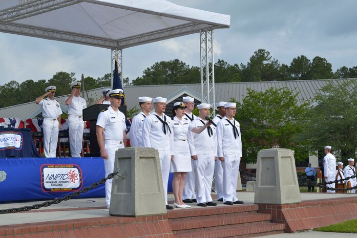 Sailors sing the national anthem during the graduation ceremony of Nuclear Power School class 1601 at Naval Nuclear Power Training Command (NNPTC) on April 22, 2016. Based at Joint Base Charleston-Naval Weapons Station, NNPTC trains Sailors in the fundamentals of design, operation, and maintenance of shipboard nuclear propulsion plants. (U.S. Navy Photo by Mass Communication Specialist 2nd Class Corey Dill)