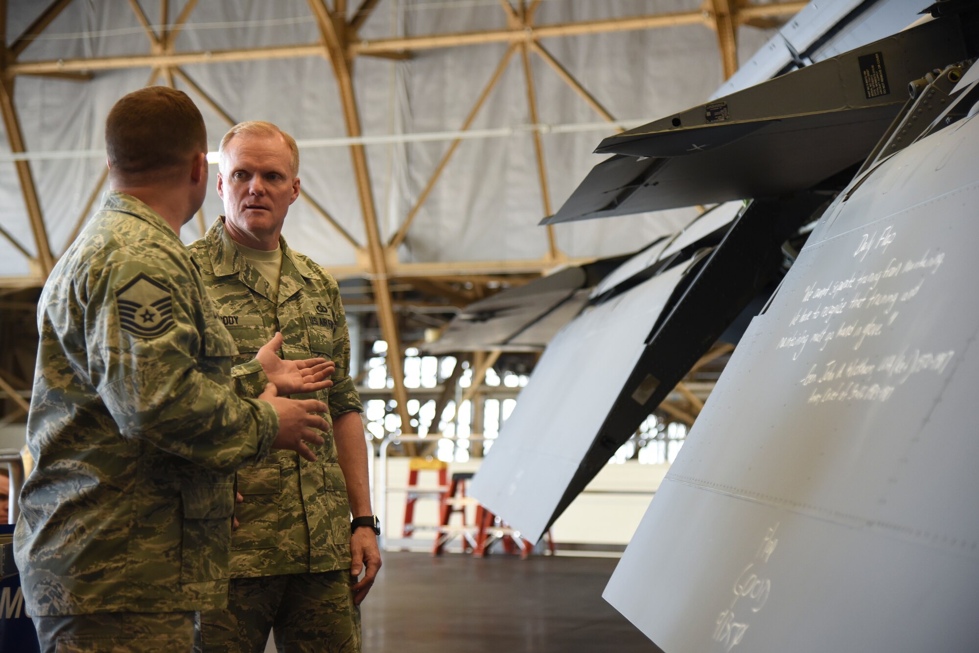 Master Sgt. Eric Laflin, 141st Air Refueling Wing periodic inspection technician, discusses the purpose behind creating “The Daily Flap” with Chief Master Sgt. of the Air Force James A. Cody May 2, 2016, at Fairchild Air Force Base, Wash. Cody visited the periodic inspection dock during his tour of the 92nd Maintenance Group. (U.S. Air Force photo/Airman 1st Class Mackenzie Richardson)