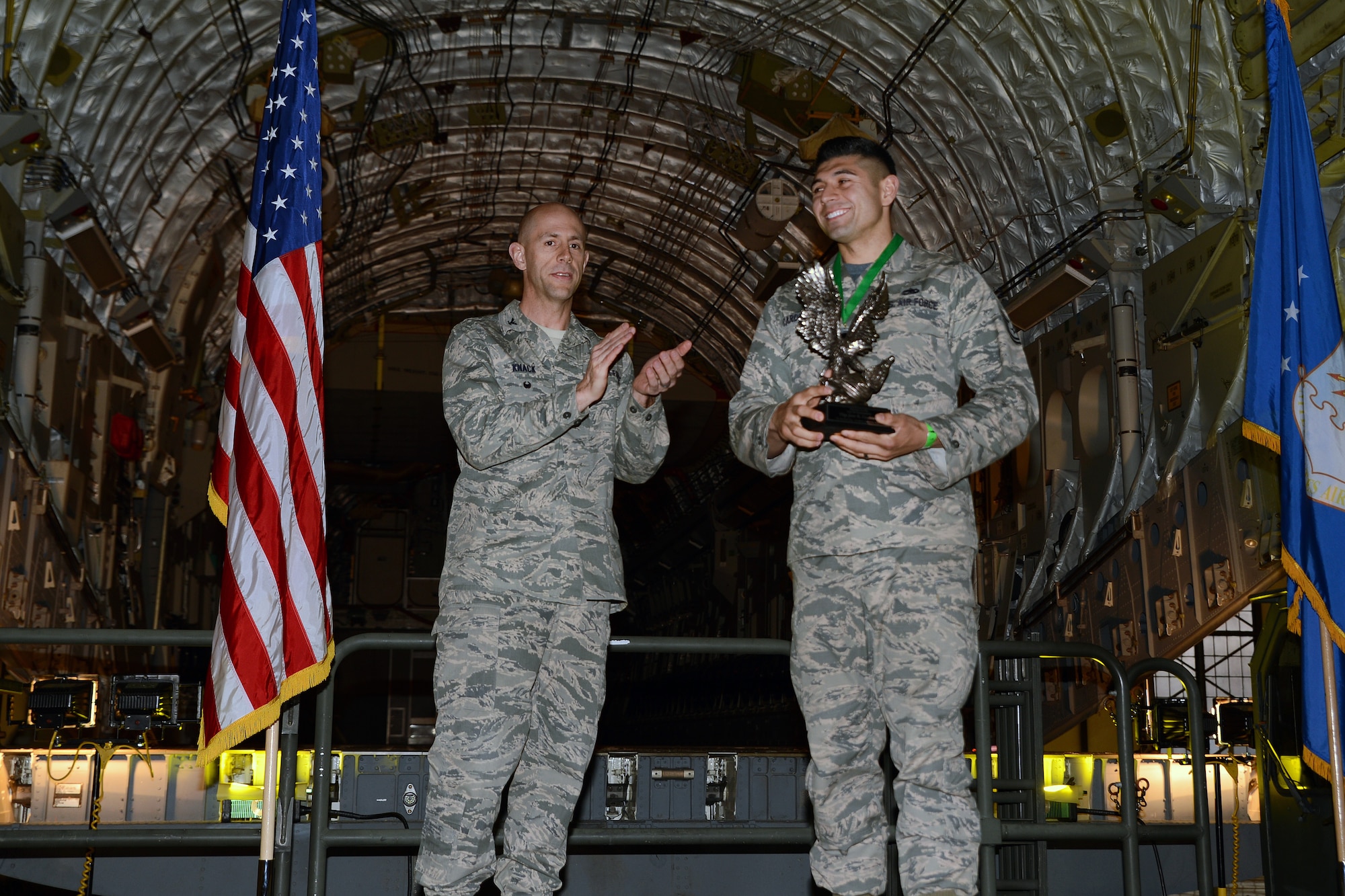 Col. John Knack, 62nd Maintenance Group deputy commander, applauds Tech. Sgt. Jose Cardenas, 62nd Aircraft Maintenance Squadron crew chief, for winning this year’s Knucklebuster award at the 2016 Log Fest Awards dinner, April 29, 2016, at Joint Base Lewis-McChord, Wash. Unlike traditional award nominees, Knucklebuster nominees are nominated by their peers for high work performance and overall character. (U.S. Air Force photo/Senior Airman Jacob Jimenez)  
