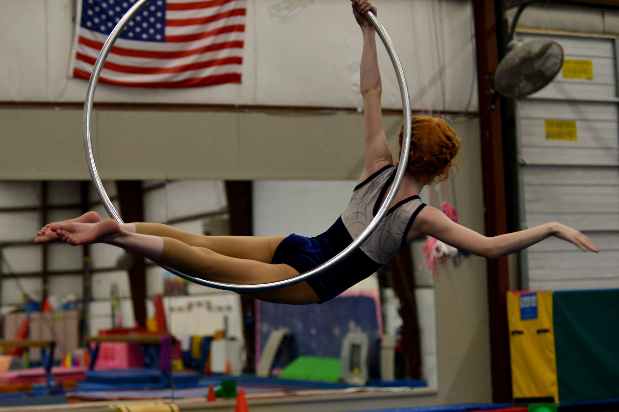 Ally Aspen, a Fort Eustis military child, poses in a performance hoop for her coach during an aerial acrobats practice in Hampton, Va., April 12, 2016. Along with winning awards in the sport, Ally was also recognized for her grades and performance in school by being inducted into the National Elementary Honor Society. (U.S. Air Force photo by Staff Sgt. Natasha Stannard)