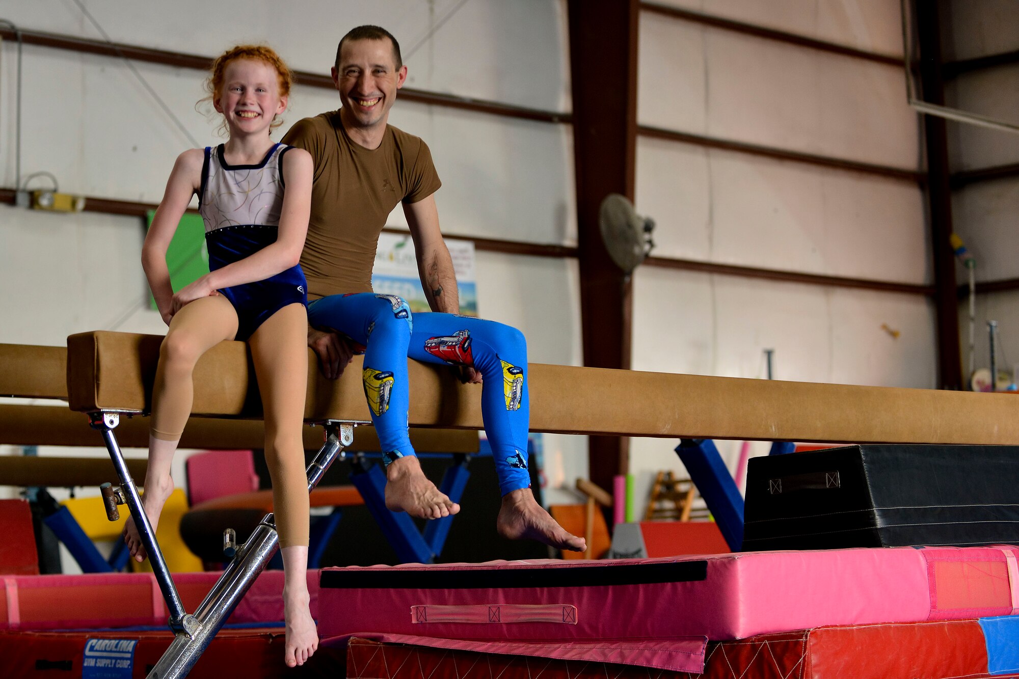 U.S. Army Staff Sgt. Zachary Bass, a small group leader with the Fort Eustis Army Aviation Center of Excellence Noncommissioned Officer Academy, and his stepdaughter, Ally Aspen, practice partner acrobatics as a way to strengthen their bond in Hampton, Va., April 26, 2016. Since practicing the sport, Ally has gained significantly more confidence, according to her parents. (U.S. Air Force photo by Staff Sgt. Natasha Stannard)