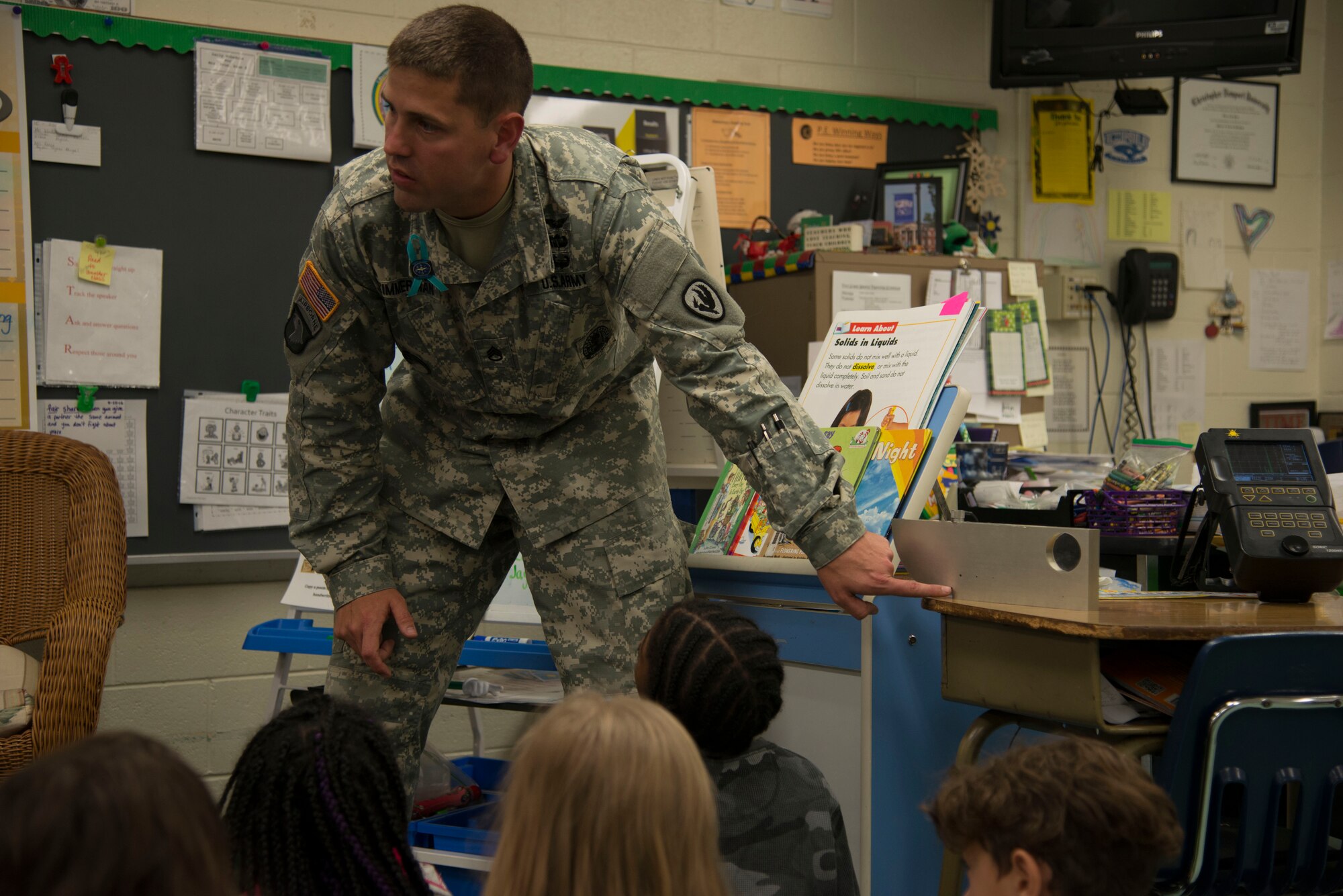 U.S. Army Staff Sgt. Kenneth Zimmerman, an instructor from the Army Aviation Center of Excellence Noncommissioned Officer Academy at Fort Eustis, Va., speaks to elementary school students about how he uses different technology to fix aircraft during a career day in Newport News, Va., April 29, 2016. The career day gave the  Richneck Elementary School students a deeper look into different careers in the Army. (U.S. Air Force photo by Senior Airman Kristina LaCoste)