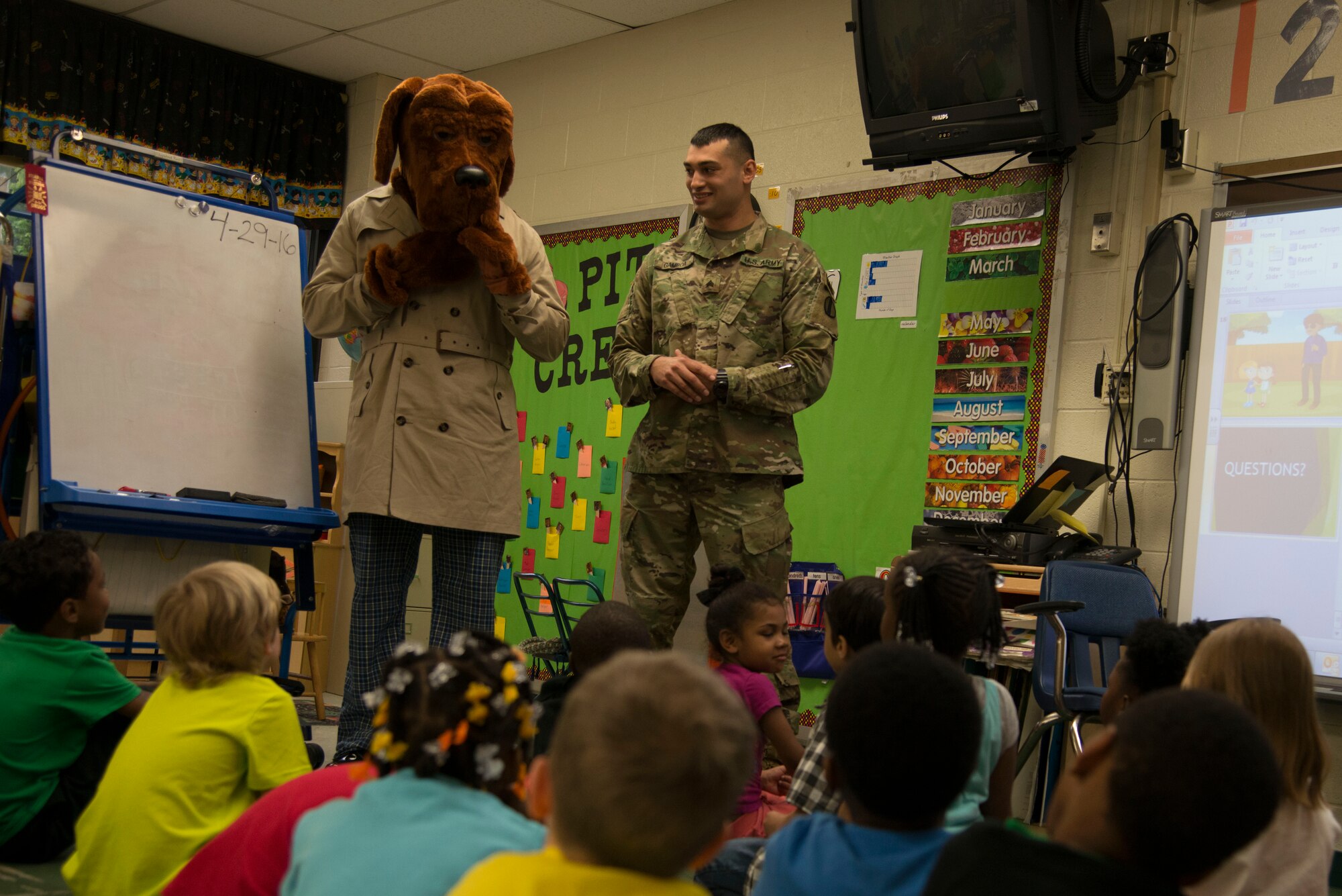 U.S. Army Sgt. Adolfo Gamboa, with the 221st Military Police Detachment and McGruff the Crime Dog from Fort Eustis, Va., talk about stranger danger and taking a bite out of crime with students during career day at Richneck Elementary school in Newport News Va., April 29, 2016. The Soldiers visited as a part of a partnership and outreach program, during which the military police went over general safety tips. (U.S. Air Force photo by Senior Airman Kristina LaCoste)