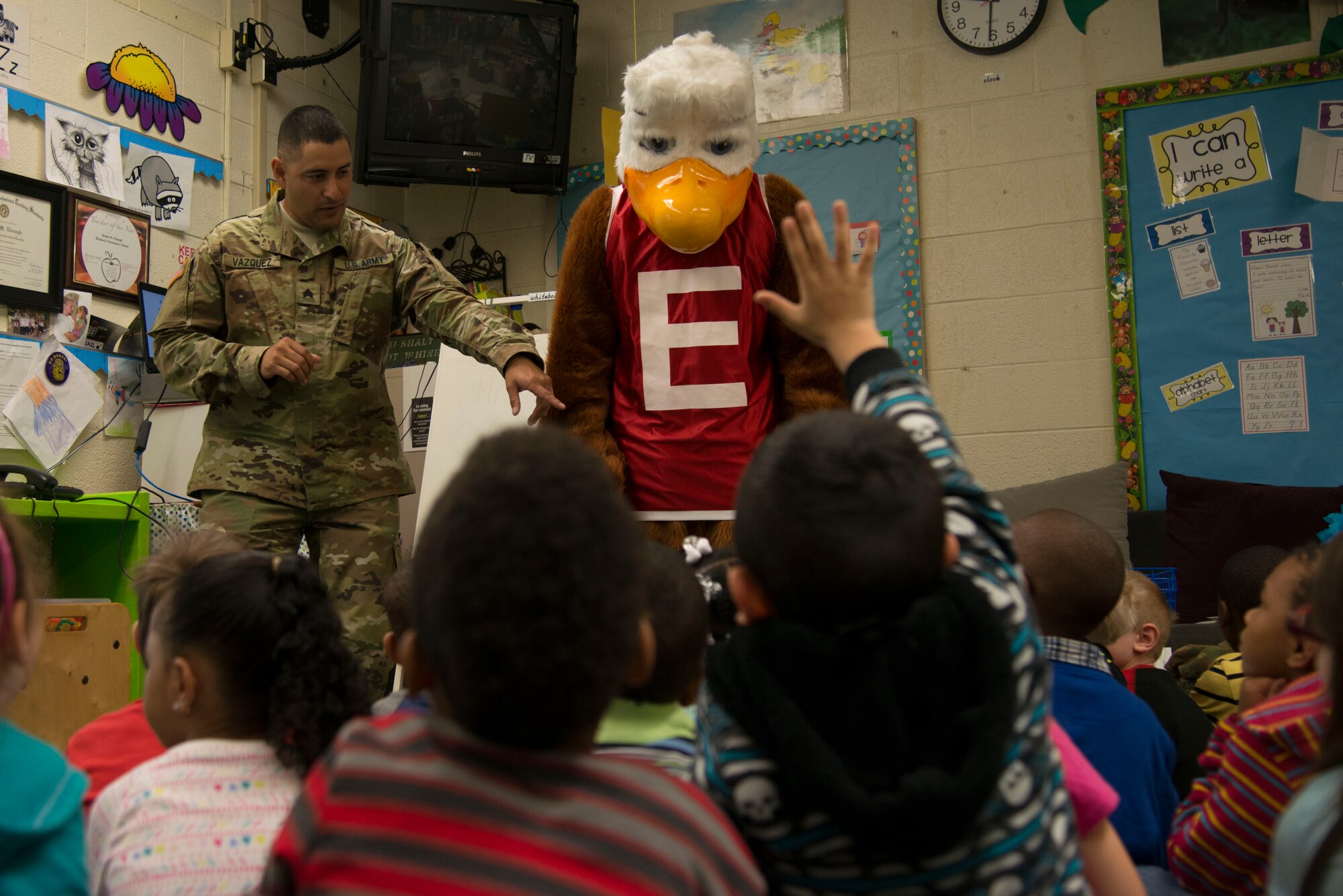 U.S. Army Sgt. Joaquin Vasquez, with the 221st Military Police Detachment, and Eddie the Eagle discuss firearm safety with kindergarten students for a career day at Richneck Elementary School in Newport News, Va., April 29, 2016. The day focused on various careers available in the Army as well as educational classes on safety. (U.S. Air Force photo by Senior Airman Kristina LaCoste)