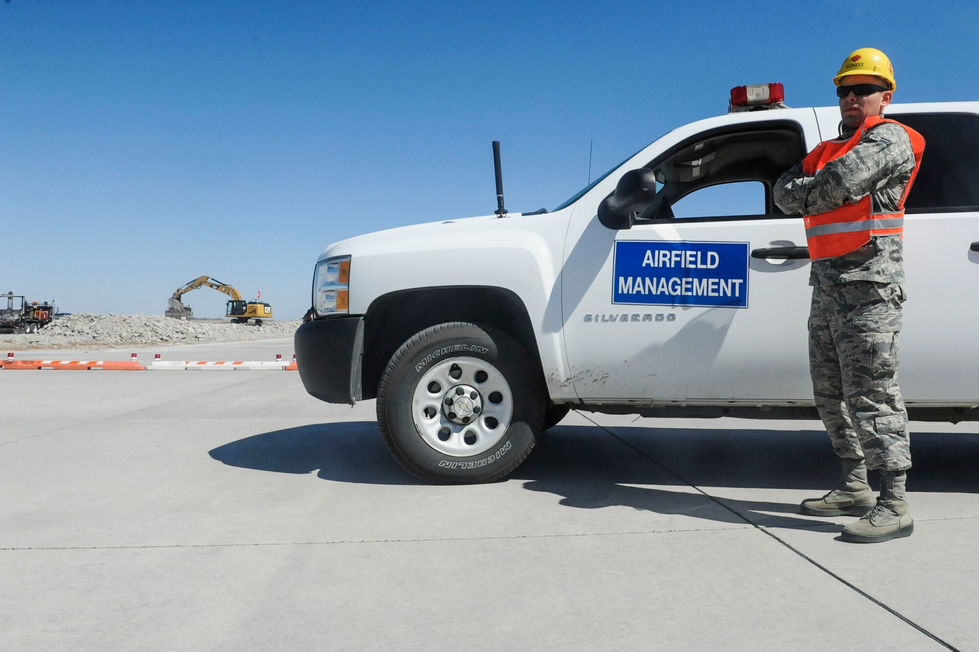 Airman 1st Class Benjamin Soto Garcia, airfield management operations coordinator assigned to the 5th Operations Support Squadron, prepares to inspect a construction site on taxiway delta and the associated hammerhead of Minot Air Force Base, N.D., April 13, 2016. Day-to-day tasks for airfield management Airmen include inspection of airfield markings, airfield signs, runway surface conditions and checking for obstacles and obstructions.  (U.S. Air Force photo/Airman 1st Class Jessica Weissman)