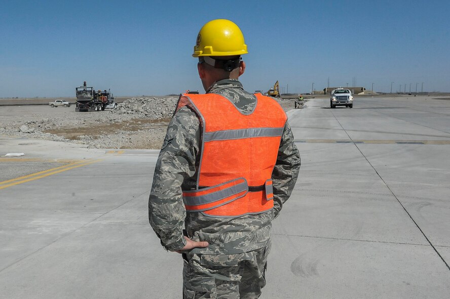 Airman 1st Class Benjamin Soto Garcia, airfield management operations coordinator assigned to the 5th Operations Support Squadron, overlooks the construction site on taxiway delta and the associated hammerhead of Minot Air Force Base, N.D., April 13, 2016. Currently this taxiway is under construction due to deteriorated conditions of the runway. (U.S. Air Force photo/Airman 1st Class Jessica Weissman)